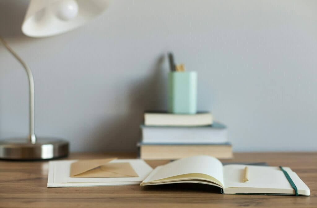 Clear Communication is Key - open notebook on desk with pen