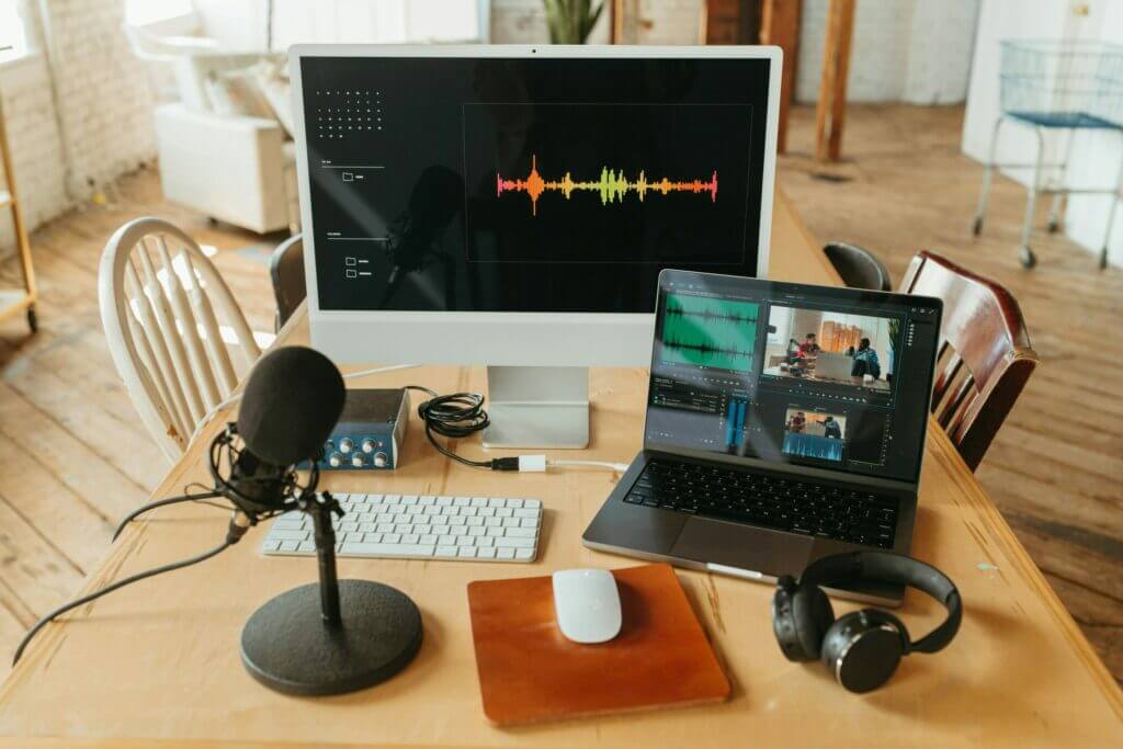 Creating the right digital content creation involves tools like microphones, headphones, computers, online programs and tools, which are shown on a desk in this photo
